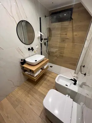 a bathroom with a sink and a toilet and a mirror at Real suite spa in Palermo