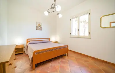 a bedroom with a bed and a desk and a window at Villa Spera in Mandra Capreria
