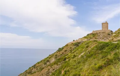 a castle on top of a hill next to the ocean at Villa Spera in Mandra Capreria