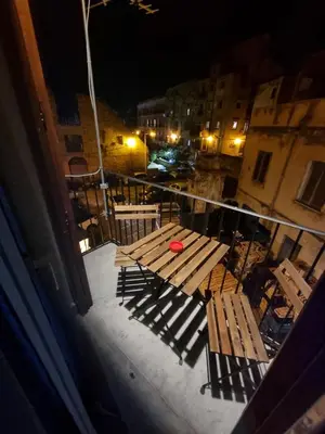 a red frisbee sitting on a wooden bench on a balcony at Residenza Tarzanà in Palermo