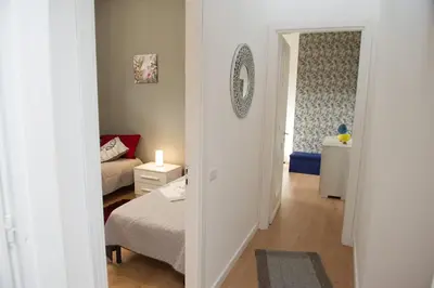 a small bedroom with a bed and a room with a window at Casa vacanze Ines in Carini