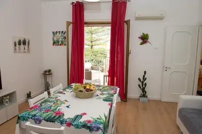 a dining room with a table with a bowl of fruit on it at Casa vacanze Ines in Carini