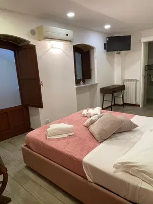a bedroom with a large bed with towels on it at Posto al Capo in Palermo