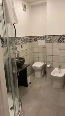 a bathroom with a toilet and a sink at Posto al Capo in Palermo
