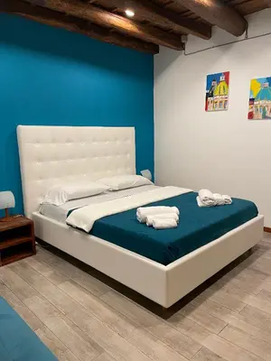 a bedroom with a bed with two towels on it at Posto al Capo in Palermo