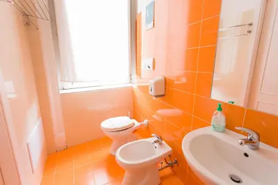 a bathroom with a toilet and a sink at A Casa di Amici in Palermo