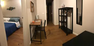 a room with a table and a room with a bed at 100 PASSI in Palermo