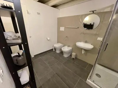 a bathroom with a sink and a toilet and a mirror at 100 PASSI in Palermo