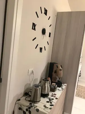 a clock on a wall above a table with pots and pans at 100 PASSI in Palermo