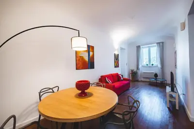 a living room with a table and a red couch at ChiChi Home in Palermo