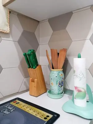 a kitchen counter with wooden utensils in a vase at Le Due Pigne - Palermo in Palermo