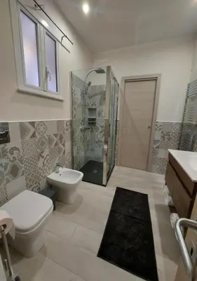 a bathroom with a toilet and a sink and a shower at Le Due Pigne - Palermo in Palermo