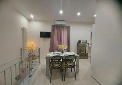 a dining room with a table and two chairs at Le Due Pigne - Palermo in Palermo