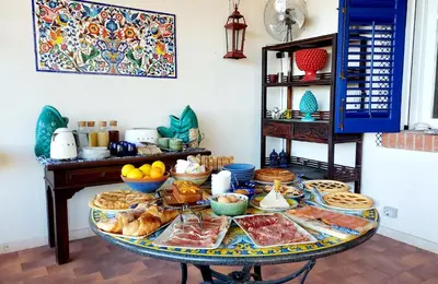 a table filled with different types of food on it at VFH Villa Flavia Eco B&B - 50 metri dal mare in Santa Flavia