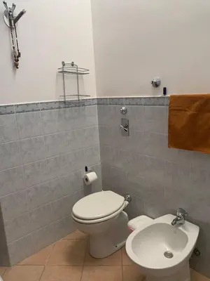 a bathroom with a toilet and a sink at MAKARI, Villetta Rocca Pirciata in Macari