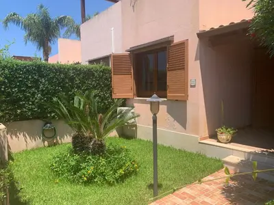 a house with a plant and a street light in the yard at MAKARI, Villetta Rocca Pirciata in Macari