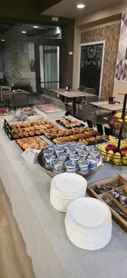 a table with plates and bowls of food on it at Hotel Elite Palermo Centro in Palermo