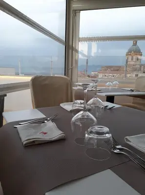 a table with two wine glasses and a view of a building at Hotel Centrale Spa & Relax in Alcamo