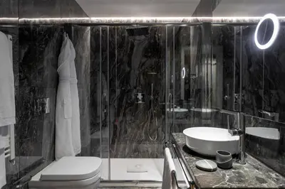 a bathroom with a toilet and a sink and a shower at Grand Hotel Et Des Palmes in Palermo