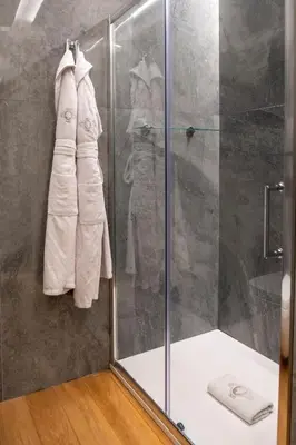 a bathroom with a shower with a glass shower stall at Grand Hotel Et Des Palmes in Palermo