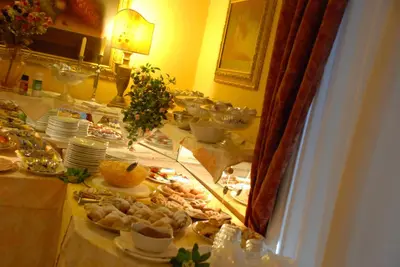 a buffet line with plates of food on a table at Hotel del Centro in Palermo