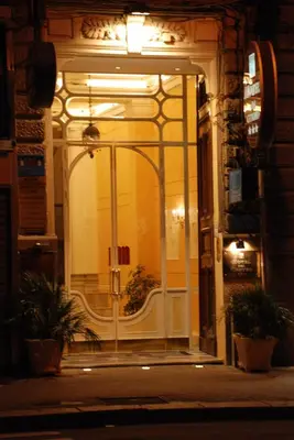 a glass door of a building at night at Hotel del Centro in Palermo