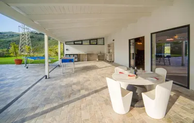 a patio with a white table and chairs at Dimora Di Famiglia in Belmonte Mezzagno