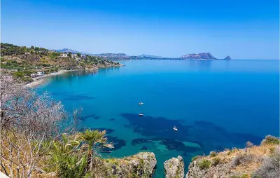 a large blue body of water with boats in it at Dimora Di Famiglia in Belmonte Mezzagno