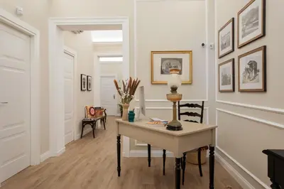 a home office with a desk and chairs in a hallway at Vossia Luxury Rooms & Sicilian Living in Palermo