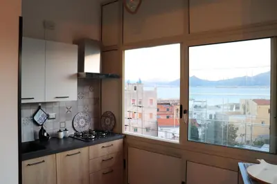 a kitchen with a large window with a view at Casa de Paoli - Vista Mare Arenella, Palermo con Parcheggio Privato in Palermo