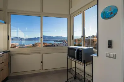 a kitchen with a large window and a television at Casa de Paoli - Vista Mare Arenella, Palermo con Parcheggio Privato in Palermo