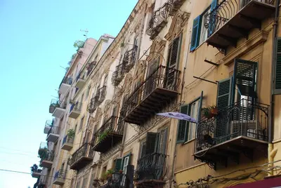 a group of buildings with balconies and an umbrella at Boutique B&B Vintage in Palermo