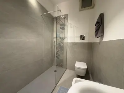 a bathroom with a toilet and a glass shower at Boutique B&B Vintage in Palermo