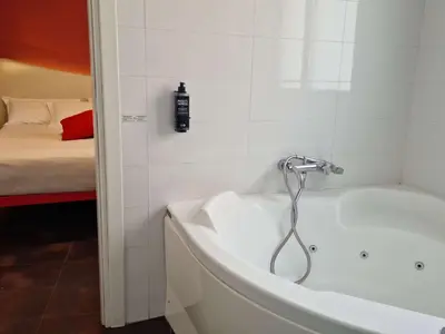 a bath tub with a shower in a bathroom at President Hotel Palermo in Palermo