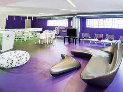 a purple room with a pair of shoes on the floor at President Hotel Palermo in Palermo