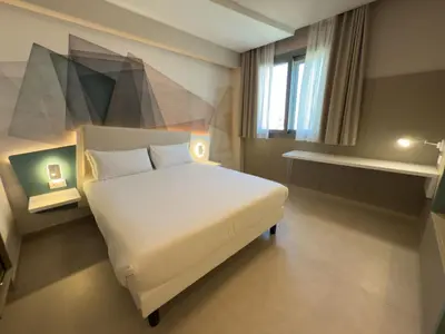 a bedroom with a white bed and a window at President Hotel Palermo in Palermo