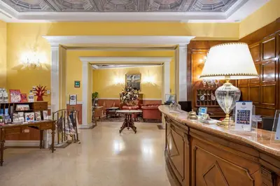 a large lobby with a hair salon with a counter at Best Western Ai Cavalieri Hotel in Palermo