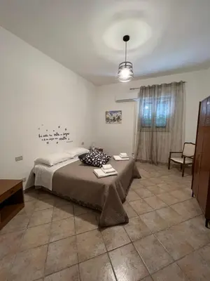 a bedroom with a bed and a table in it at House Corso Calatafimi in Palermo