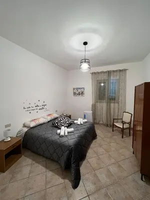 a bedroom with a bed with two stuffed animals on it at House Corso Calatafimi in Palermo