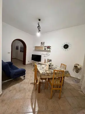 a living room with a table and a blue couch at House Corso Calatafimi in Palermo