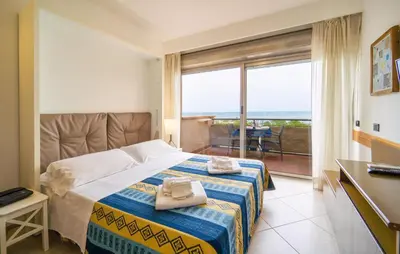 a bedroom with a bed with a view of the ocean at Mono 2 in Lido di Mondello