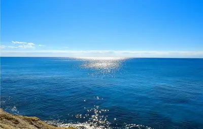 a large body of water with the sun reflecting on it at Mono 2 in Lido di Mondello