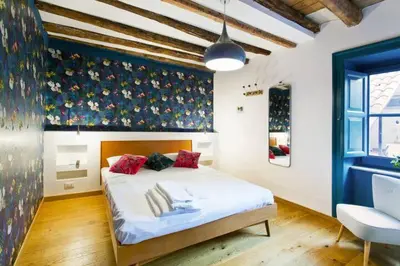 a bedroom with a large white bed with red pillows at Casa del Vinile in Palermo