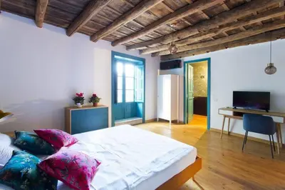 a bedroom with a bed with pillows and a desk at Casa del Vinile in Palermo