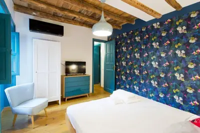 a bedroom with a bed and a blue wall at Casa del Vinile in Palermo