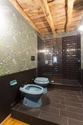 a bathroom with a blue toilet and a shower at Casa del Vinile in Palermo