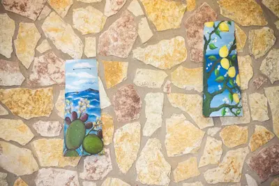 two ties sitting on top of a stone wall at HolidaySicily Alcamo Marina in Alcamo Marina