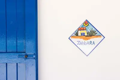 a kite with a picture of a house next to a door at HolidaySicily Alcamo Marina in Alcamo Marina