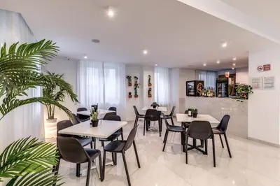 a restaurant with tables and chairs and a plant at Casena Dei Colli, Sure Hotel Collection By Best Western in Palermo