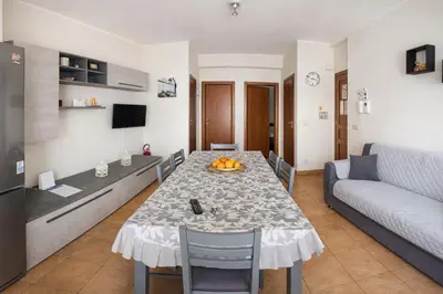 a living room with a table and a couch at La casa di Angy in Terrasini